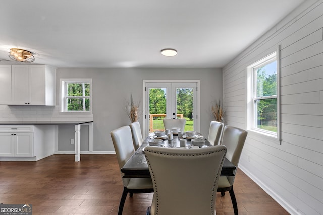 dining area featuring baseboards, dark wood-type flooring, and french doors