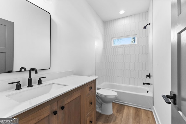 bathroom with shower / bath combination, vanity, toilet, and wood finished floors