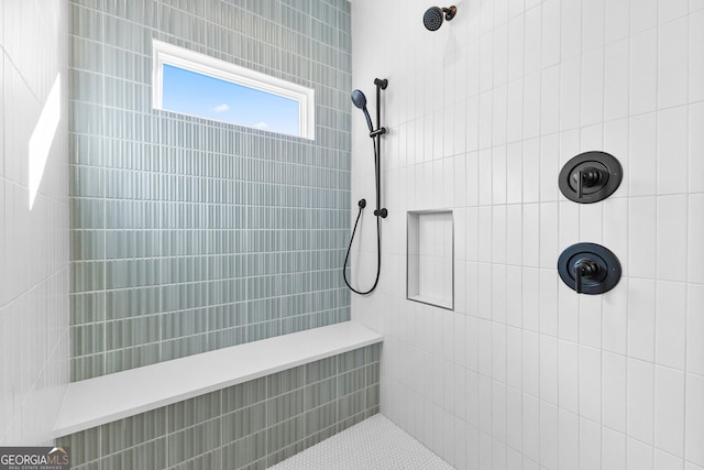 bathroom with a tile shower