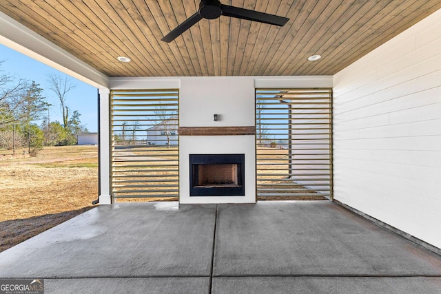 view of patio / terrace featuring ceiling fan and an outdoor fireplace