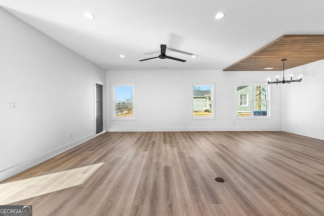 unfurnished living room featuring baseboards, wood finished floors, and recessed lighting