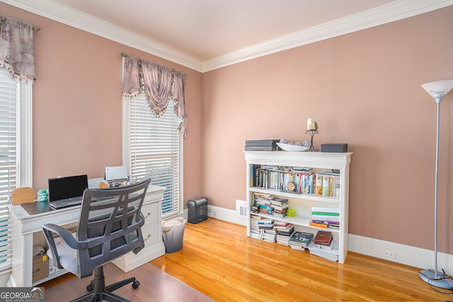 office with ornamental molding and hardwood / wood-style floors