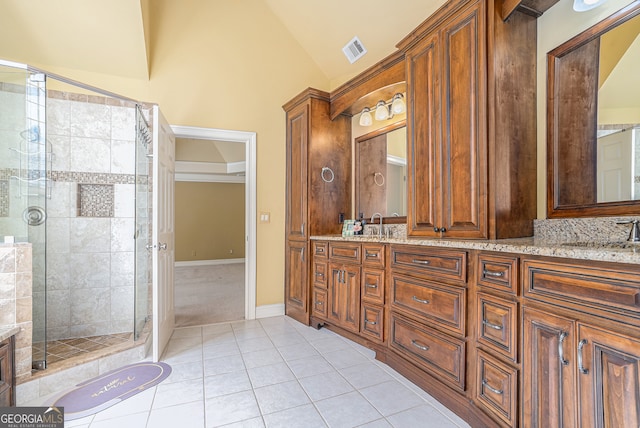 bathroom featuring walk in shower, vanity, high vaulted ceiling, and tile patterned floors