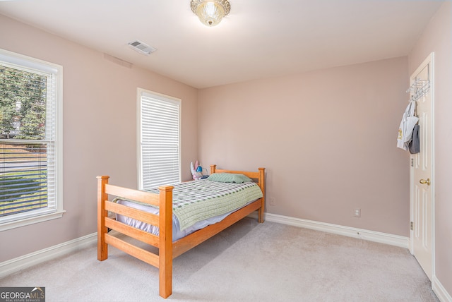 bedroom with light carpet