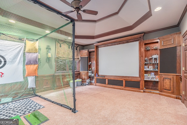 home theater room featuring carpet flooring, ornamental molding, and ceiling fan