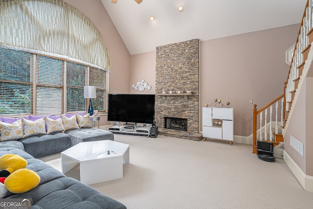 living room with carpet, a fireplace, and high vaulted ceiling