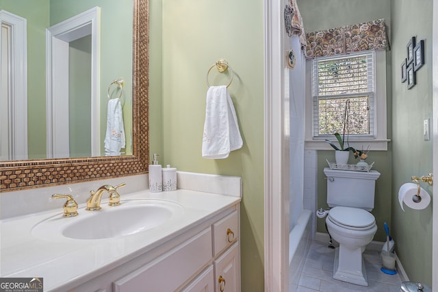 bathroom with tile patterned flooring, vanity, and toilet