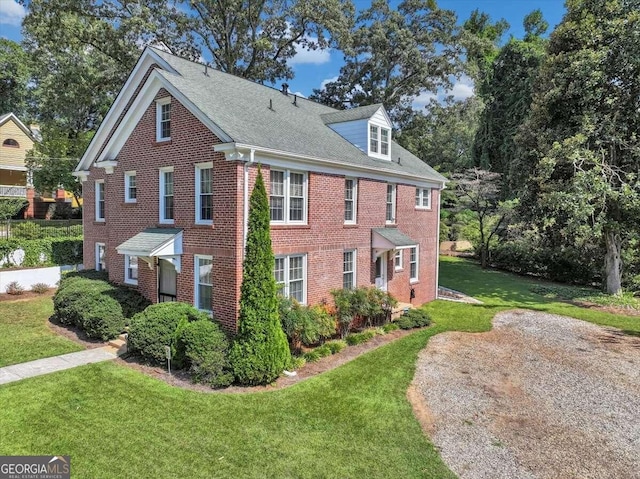 view of side of property with a yard