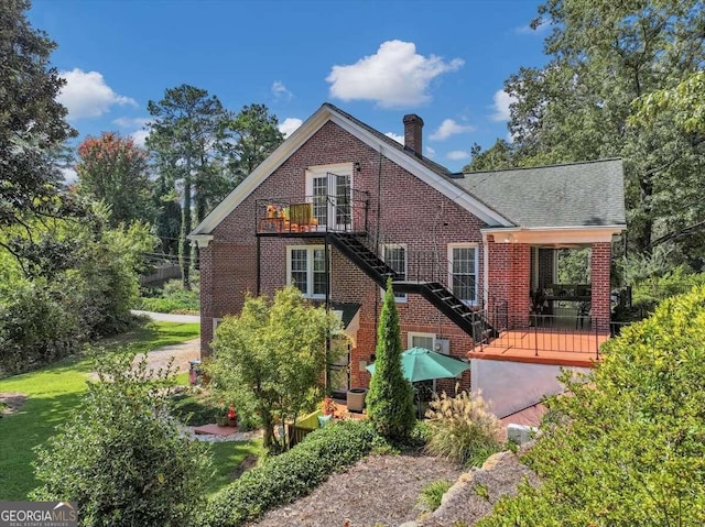 rear view of property with cooling unit, a deck, and a lawn