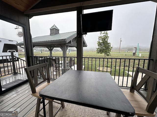 deck with a yard and outdoor dining area