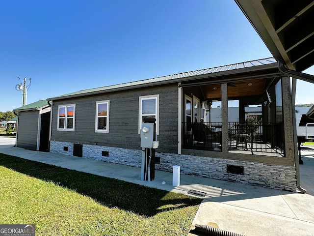 view of side of property featuring a yard and crawl space