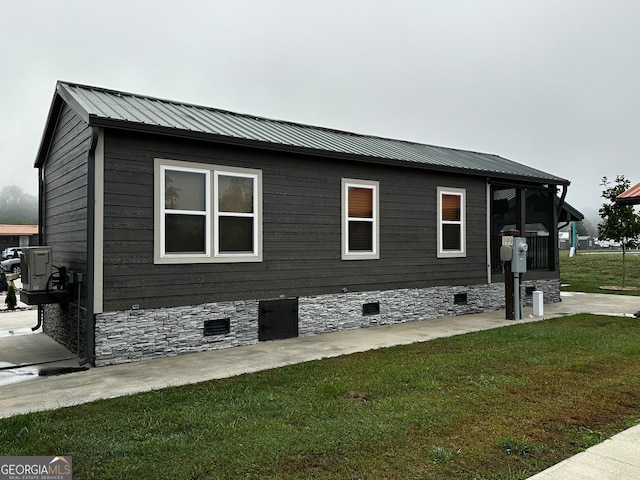 view of side of home featuring a yard