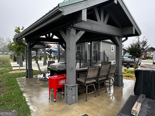 view of patio / terrace featuring a gazebo and a grill