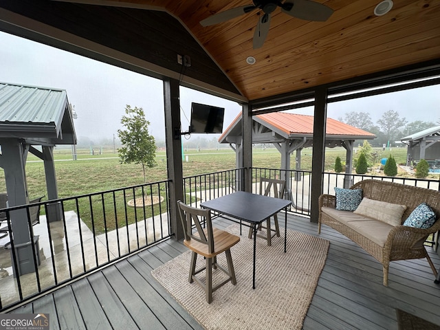 exterior space featuring wood ceiling, vaulted ceiling, and ceiling fan