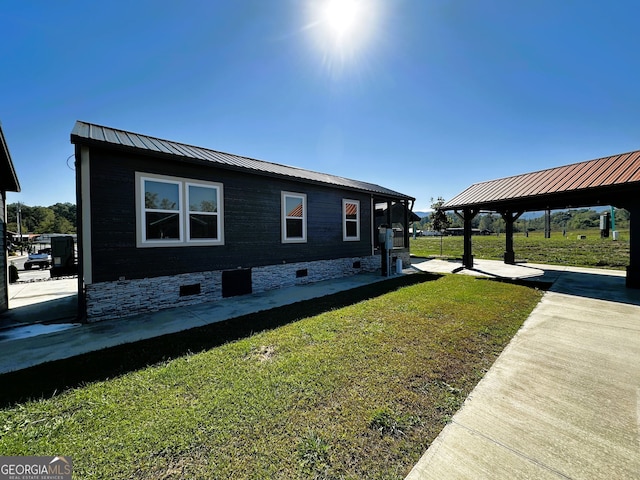 view of side of property with a gazebo and a yard