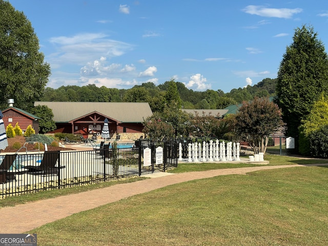 surrounding community with a lawn and a pool