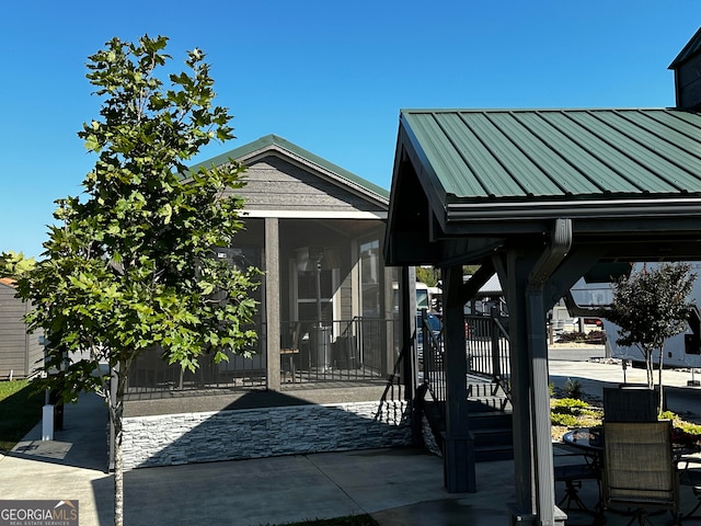 view of patio with a sunroom