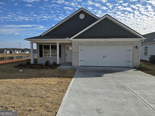 view of front of home featuring a front lawn, a garage, and cooling unit