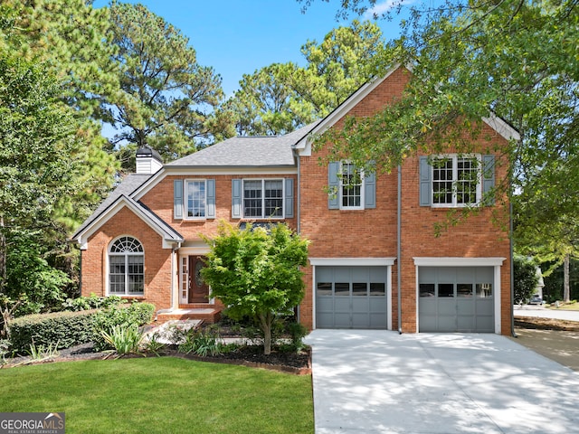 view of front of house featuring a garage and a front yard