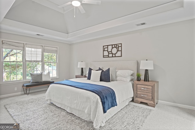 bedroom featuring ceiling fan, carpet floors, a tray ceiling, and ornamental molding