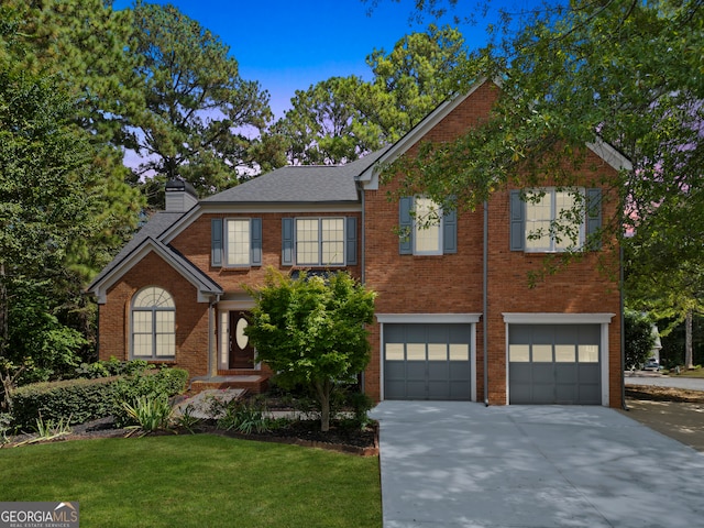 view of front of home with a garage and a front yard