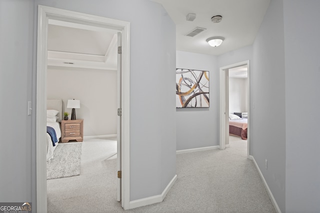 corridor with light colored carpet