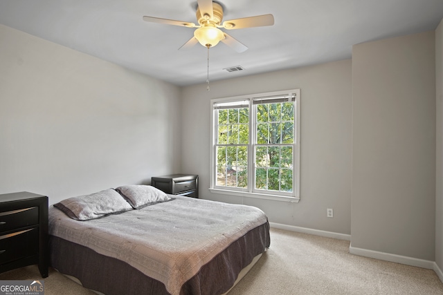 bedroom with light carpet and ceiling fan