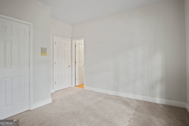 empty room featuring light carpet