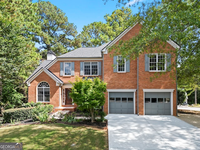 view of front of home featuring a front lawn and a garage