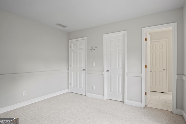 unfurnished bedroom with light carpet