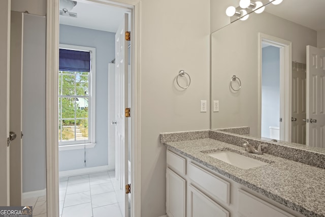 bathroom featuring tile patterned flooring, vanity, and toilet