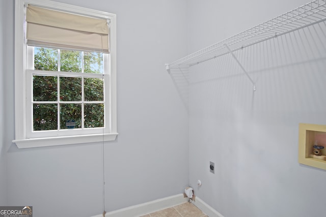 clothes washing area with washer hookup, hookup for a gas dryer, hookup for an electric dryer, and a wealth of natural light