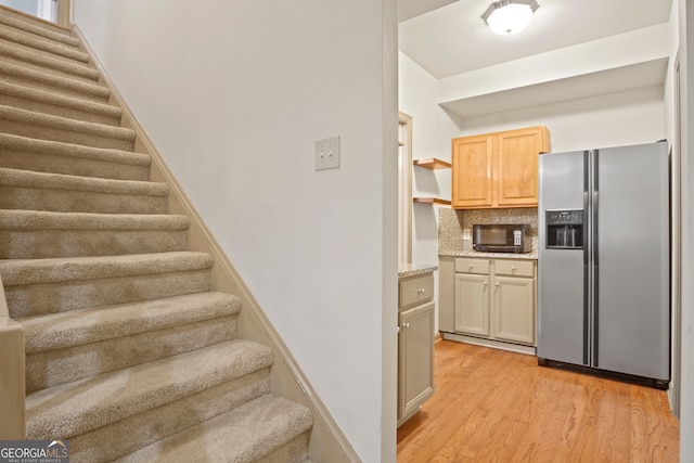 staircase with hardwood / wood-style floors