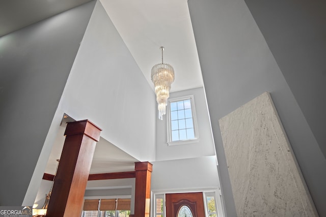 interior space featuring a notable chandelier, a towering ceiling, and a wealth of natural light