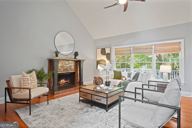 living room with ceiling fan, hardwood / wood-style flooring, and high vaulted ceiling