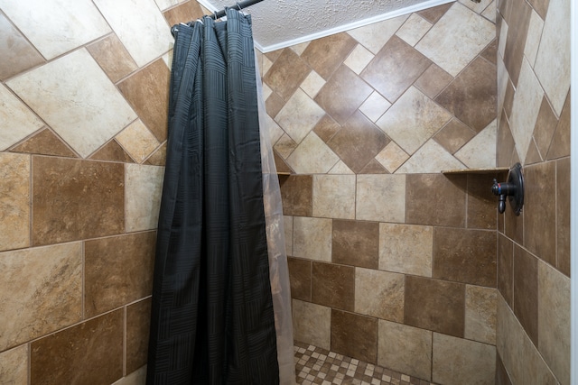 details with a textured ceiling and a shower with curtain