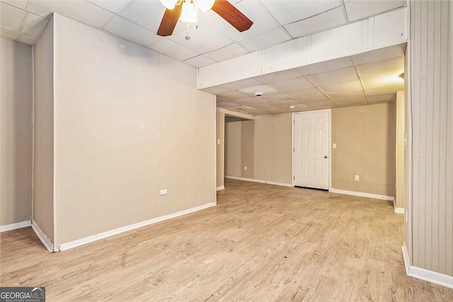 spare room with ceiling fan, a drop ceiling, and light hardwood / wood-style floors