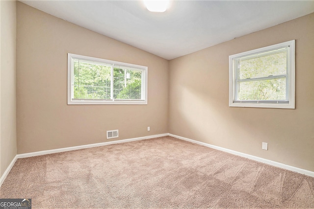 unfurnished room with carpet flooring and vaulted ceiling