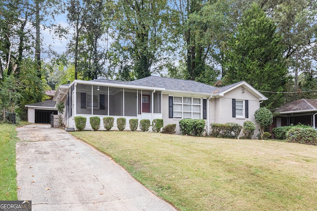 single story home with a front lawn and a sunroom