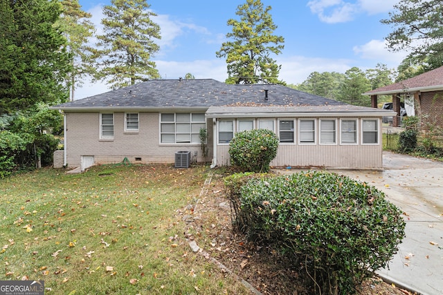 rear view of property with a yard, a patio, and central AC