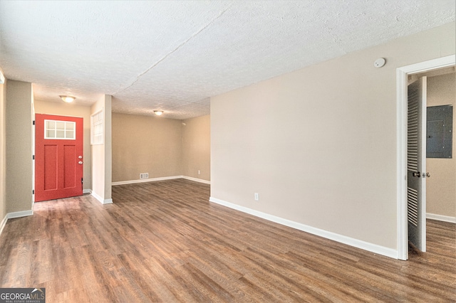 interior space featuring a textured ceiling and dark hardwood / wood-style floors