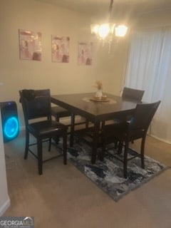 dining area with an inviting chandelier