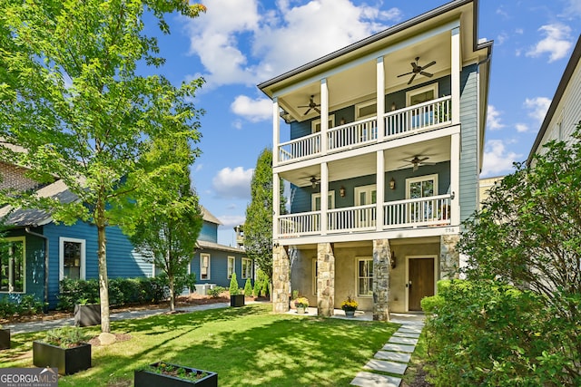 view of front of home with a front lawn, ceiling fan, a patio, and a balcony