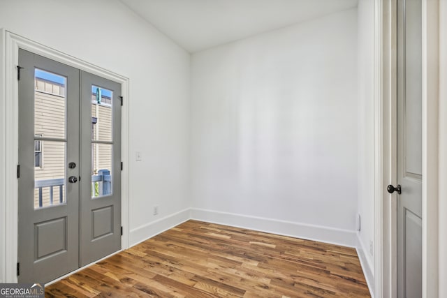 entryway with hardwood / wood-style flooring and french doors