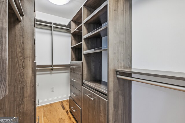 spacious closet featuring light hardwood / wood-style floors