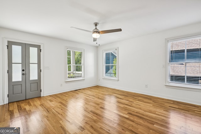 interior space with ceiling fan, light wood-type flooring, and french doors