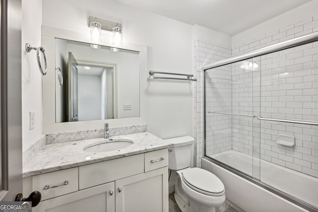 full bathroom featuring vanity, toilet, and combined bath / shower with glass door