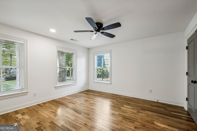 unfurnished room with wood-type flooring and ceiling fan