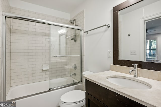 full bathroom featuring bath / shower combo with glass door, vanity, and toilet