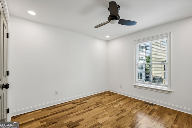 empty room featuring ceiling fan and light wood-type flooring